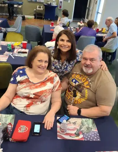 Mimi Bowie with guests at an event | New Day Lifestyle for Seniors