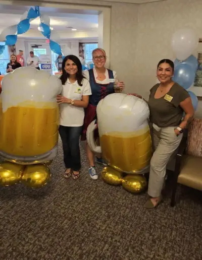 Senior care advisor attending a festive Oktoberfest social gathering | New Day Lifestyle for Seniors