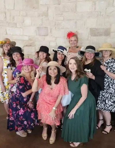 Senior care advisor gathered with attendees at a tea party social | New Day Lifestyle for Seniors