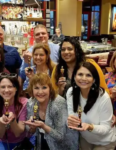 Senior care placement advisors with small award statuettes | New Day Lifestyle for Seniors