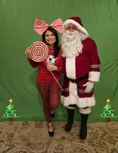 Senior care placement specialist with Santa Claus at a holiday celebration | New Day Lifestyle for Seniors