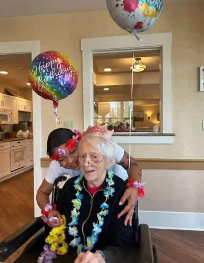 Senior care staff celebrating resident birthday | New Day Lifestyle for Seniors
